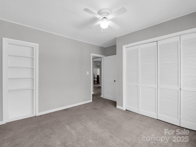 unfurnished bedroom with carpet floors, a ceiling fan, and baseboards