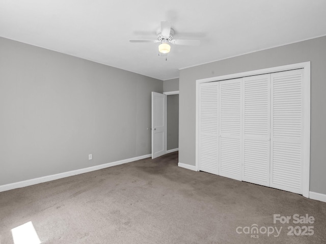 unfurnished bedroom with carpet floors, a closet, a ceiling fan, and baseboards