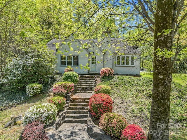 view of front of property with a chimney and stairway