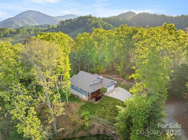 bird's eye view with a mountain view and a forest view