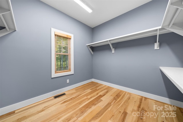 spacious closet with visible vents and wood finished floors