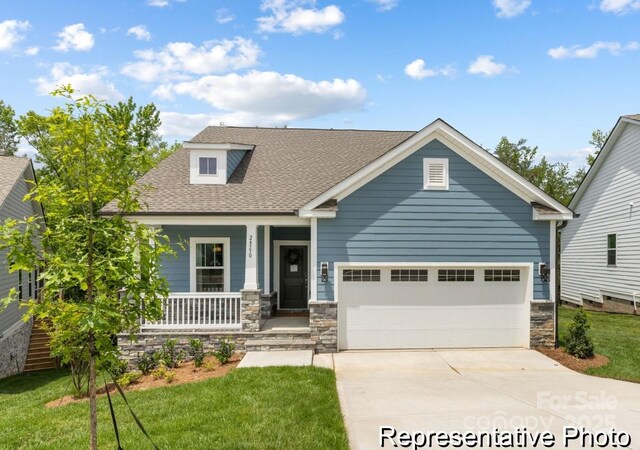 24558 Blue Heron Cir Unit 402, Lancaster, SC 29720 - craftsman-style house featuring concrete driveway, stone siding, a garage, and covered porch