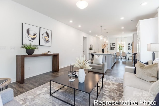 24558 Blue Heron Cir Unit 402, Lancaster, SC 29720 - living room with dark wood-style flooring, baseboards, an inviting chandelier, recessed lighting, and visible vents