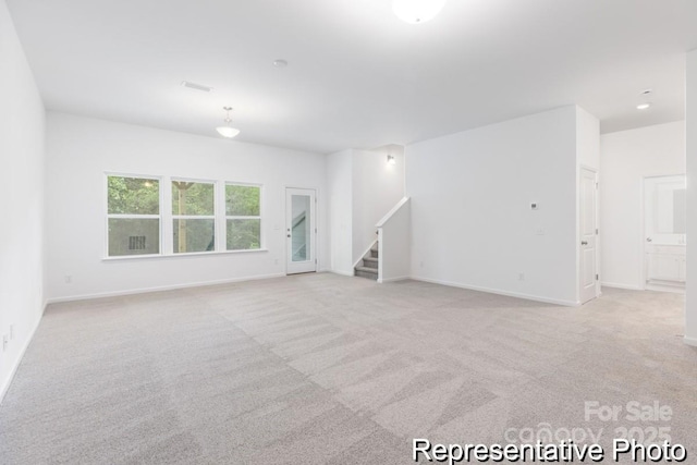 24558 Blue Heron Cir Unit 402, Lancaster, SC 29720 - unfurnished living room featuring stairway, visible vents, light colored carpet, and baseboards