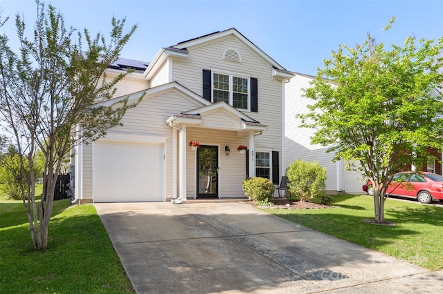 8917 Chalkstone Rd, Charlotte, NC 28216 - traditional-style house with roof mounted solar panels, an attached garage, a front lawn, and driveway