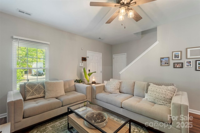 8917 Chalkstone Rd, Charlotte, NC 28216 - living area featuring stairway, wood finished floors, visible vents, a ceiling fan, and baseboards