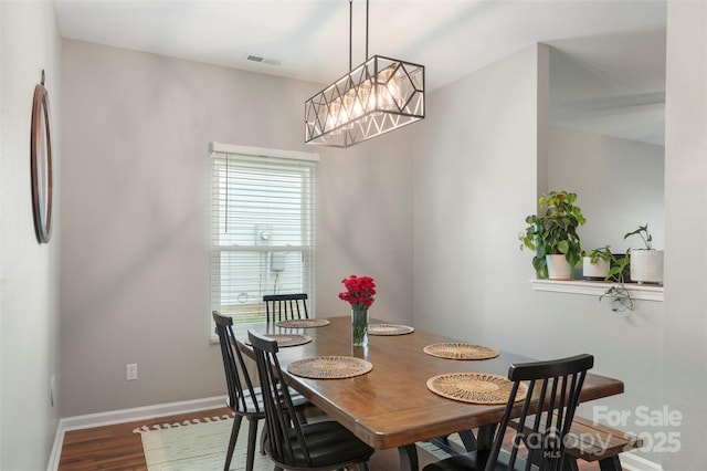 8917 Chalkstone Rd, Charlotte, NC 28216 - dining room featuring wood finished floors, visible vents, and baseboards