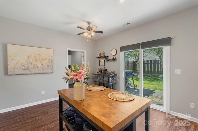 8917 Chalkstone Rd, Charlotte, NC 28216 - dining area with baseboards, ceiling fan, and dark wood finished floors
