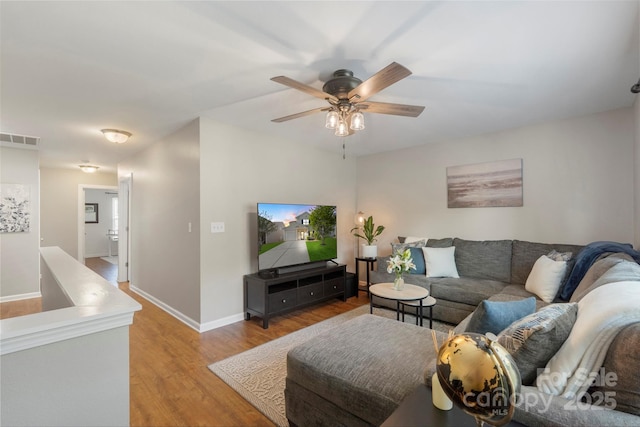 8917 Chalkstone Rd, Charlotte, NC 28216 - living room featuring baseboards, a ceiling fan, visible vents, and light wood-style flooring