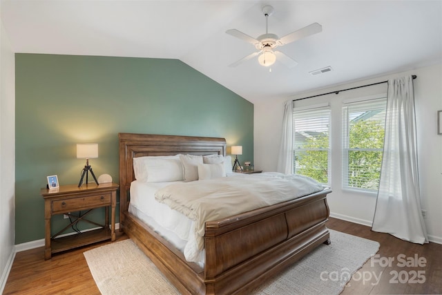 8917 Chalkstone Rd, Charlotte, NC 28216 - bedroom with vaulted ceiling, a ceiling fan, wood finished floors, baseboards, and visible vents