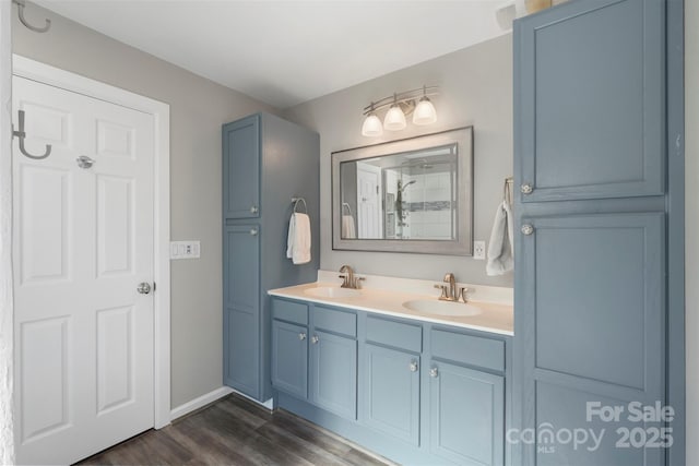 8917 Chalkstone Rd, Charlotte, NC 28216 - full bathroom with walk in shower, wood finished floors, a sink, and double vanity