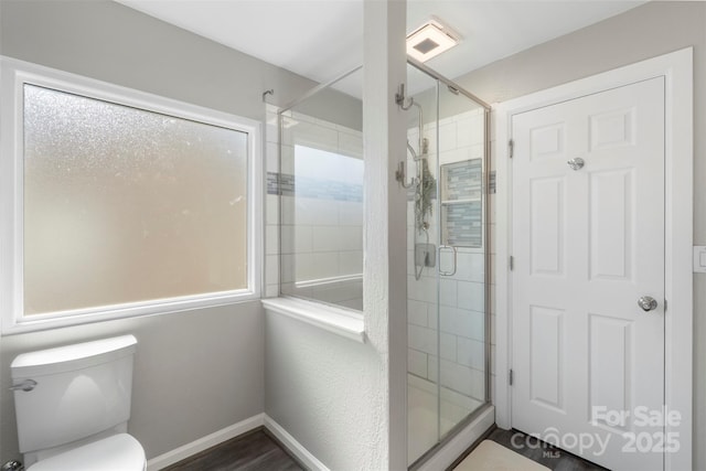 8917 Chalkstone Rd, Charlotte, NC 28216 - full bath with a shower stall, toilet, baseboards, and wood finished floors
