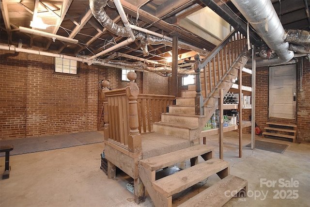 below grade area with brick wall and stairway