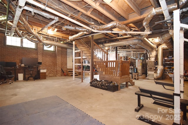 basement with gas water heater, brick wall, stairs, and heating unit
