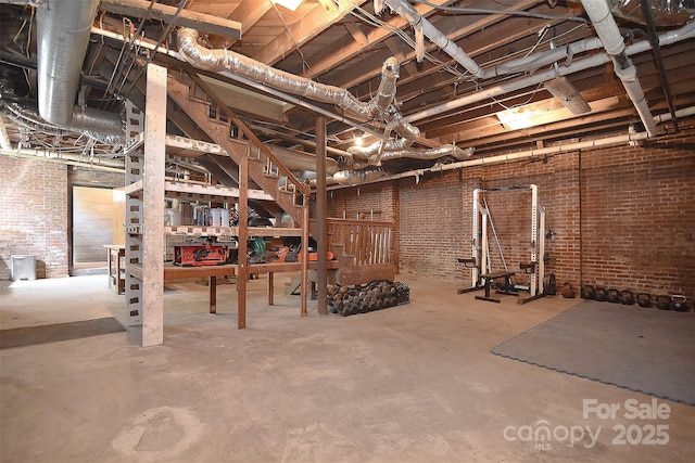 unfinished basement featuring brick wall