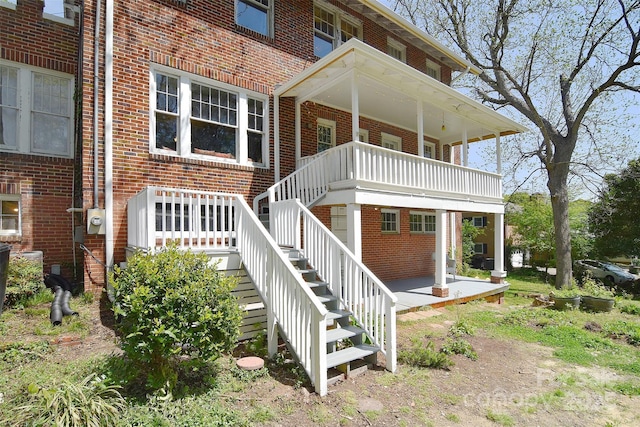 rear view of house featuring brick siding