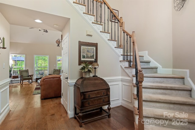 4516 Stryker Dr, Matthews, NC 28104 - stairs featuring wood-type flooring, ceiling fan, and wainscoting