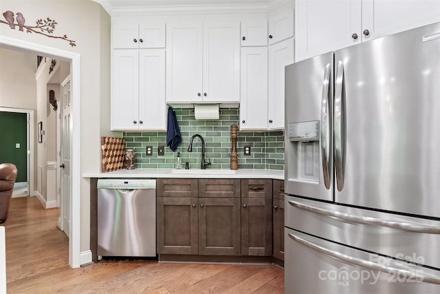 4516 Stryker Dr, Matthews, NC 28104 - kitchen featuring appliances with stainless steel finishes, light wood-type flooring, light countertops, and a sink