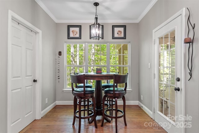 4516 Stryker Dr, Matthews, NC 28104 - dining room with ornamental molding, wood finished floors, and baseboards