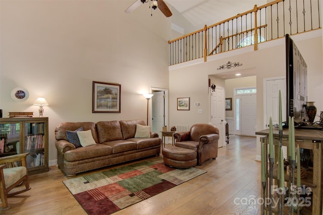 4516 Stryker Dr, Matthews, NC 28104 - living area with a towering ceiling, a ceiling fan, visible vents, and light wood-style flooring