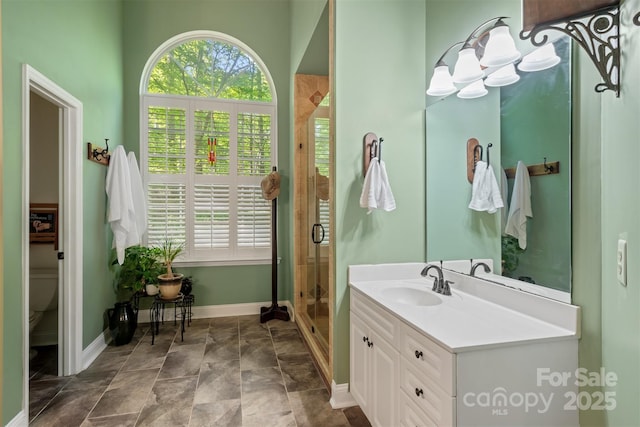 4516 Stryker Dr, Matthews, NC 28104 - full bath with baseboards, stone finish flooring, a stall shower, and vanity