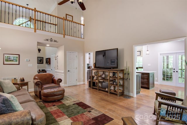 4516 Stryker Dr, Matthews, NC 28104 - living area with ceiling fan, french doors, light wood-style flooring, and a high ceiling
