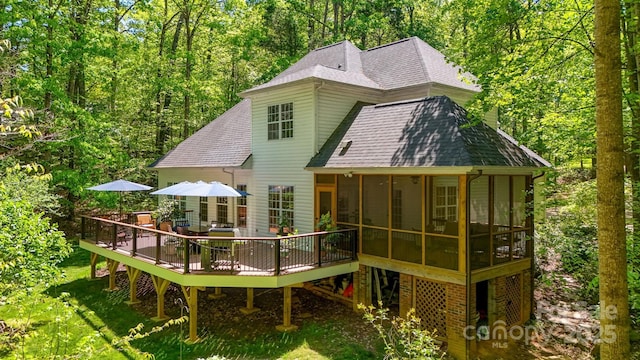4516 Stryker Dr, Matthews, NC 28104 - back of house featuring a chimney, a wooden deck, a sunroom, and roof with shingles