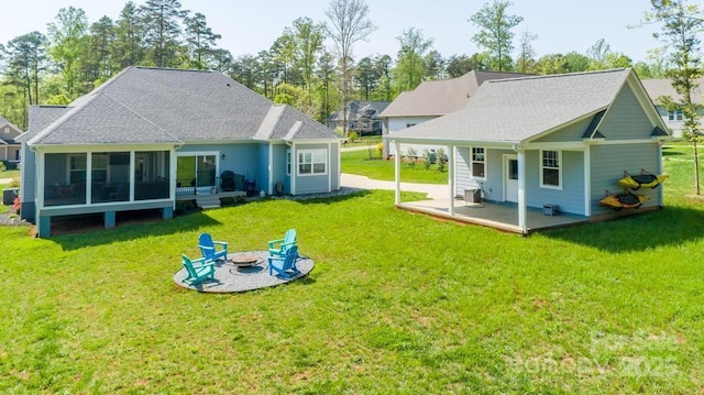 4594 N Wynswept Dr, Maiden, NC 28650 - back of property with a fire pit, central AC unit, a sunroom, and a yard