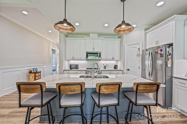 4594 N Wynswept Dr, Maiden, NC 28650 - kitchen with white cabinetry, crown molding, stainless steel appliances, and a sink