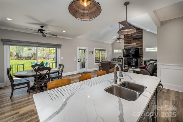 4594 N Wynswept Dr, Maiden, NC 28650 - kitchen featuring wood finished floors, a ceiling fan, a sink, crown molding, and open floor plan