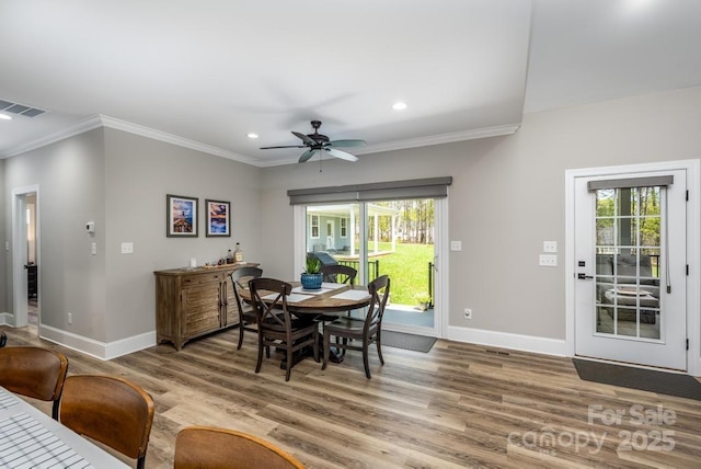 4594 N Wynswept Dr, Maiden, NC 28650 - dining room featuring crown molding, wood finished floors, plenty of natural light, baseboards, and visible vents