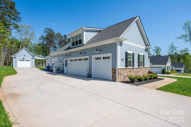 4594 N Wynswept Dr, Maiden, NC 28650 - view of home's exterior featuring concrete driveway, roof with shingles, stone siding, and a garage