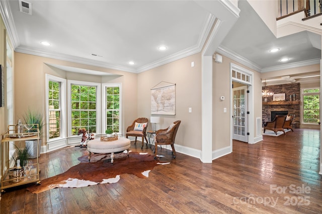 14130 Lea Point Ct, Huntersville, NC 28078 - living area featuring hardwood / wood-style floors, a stone fireplace, baseboards, ornamental molding, and recessed lighting