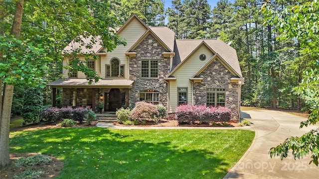 14130 Lea Point Ct, Huntersville, NC 28078 - craftsman-style home featuring stone siding, a porch, and a front lawn