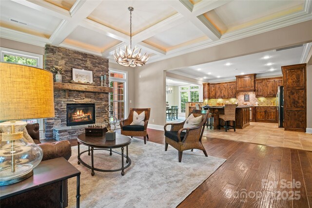 14130 Lea Point Ct, Huntersville, NC 28078 - living room with light wood-style flooring, a stone fireplace, crown molding, beamed ceiling, and coffered ceiling