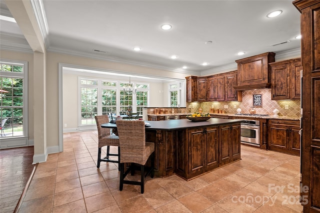 14130 Lea Point Ct, Huntersville, NC 28078 - kitchen with appliances with stainless steel finishes, ornamental molding, tasteful backsplash, plenty of natural light, and a kitchen breakfast bar