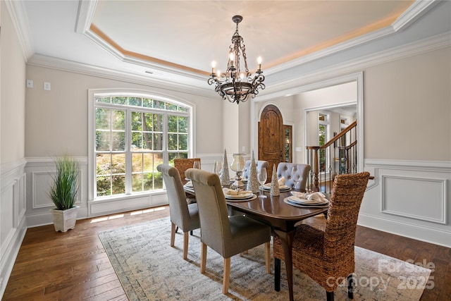 14130 Lea Point Ct, Huntersville, NC 28078 - dining room featuring a chandelier, a raised ceiling, wood-type flooring, crown molding, and a wainscoted wall