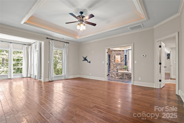 14130 Lea Point Ct, Huntersville, NC 28078 - spare room with a raised ceiling, a ceiling fan, hardwood / wood-style flooring, baseboards, and crown molding