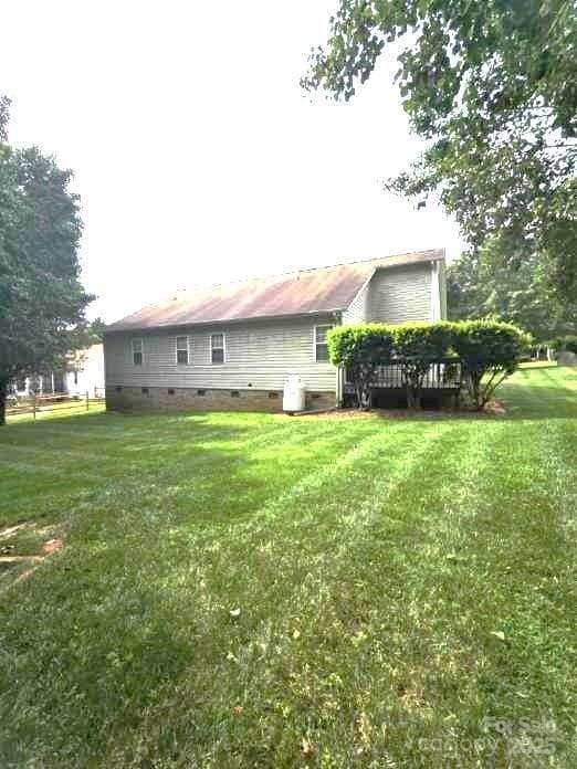 317 Robert Keever Rd, Stanley, NC 28164 - back of house with crawl space, a lawn, and a wooden deck