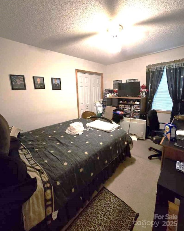 317 Robert Keever Rd, Stanley, NC 28164 - carpeted bedroom featuring ceiling fan, a textured ceiling, and a closet