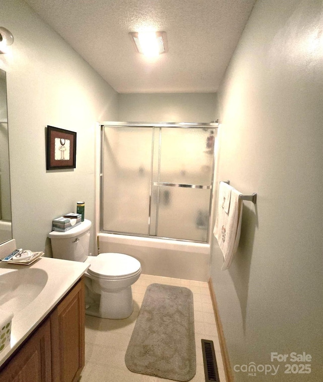 317 Robert Keever Rd, Stanley, NC 28164 - full bath featuring vanity, a textured ceiling, toilet, bath / shower combo with glass door, and tile patterned floors