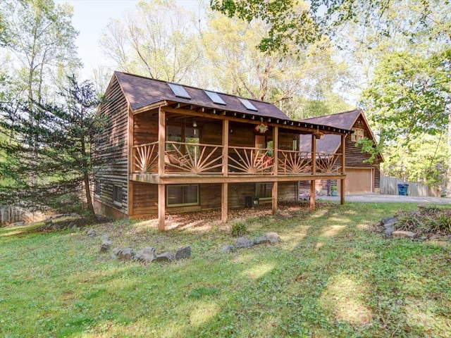rear view of property with a yard and a garage