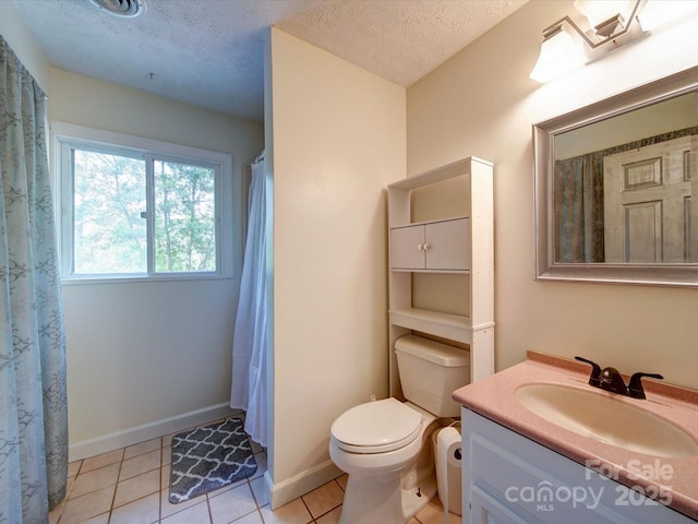 bathroom featuring baseboards, toilet, a textured ceiling, vanity, and tile patterned flooring