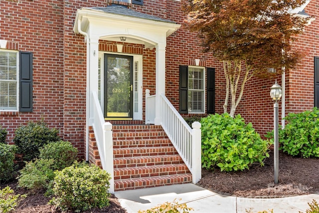 property entrance with brick siding