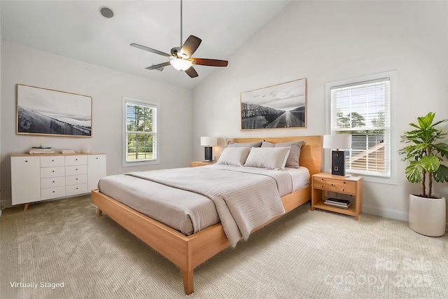 bedroom featuring light colored carpet, baseboards, a ceiling fan, and high vaulted ceiling