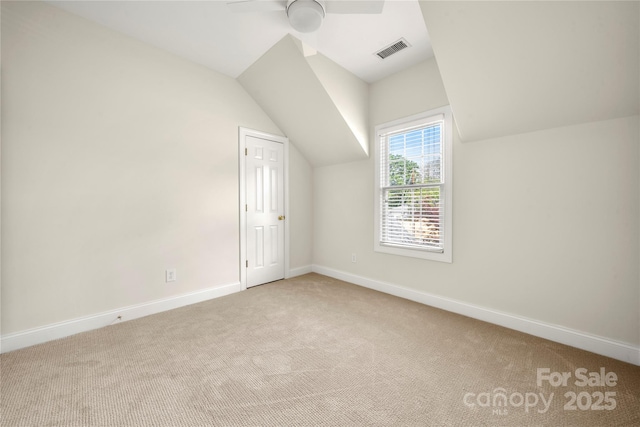 bonus room with vaulted ceiling, a ceiling fan, carpet floors, baseboards, and visible vents