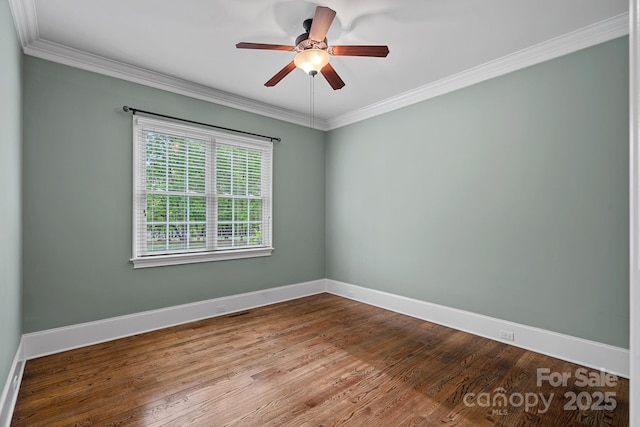 empty room featuring ceiling fan, wood finished floors, baseboards, and ornamental molding