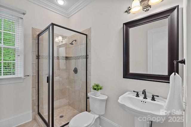 bathroom with a healthy amount of sunlight, ornamental molding, baseboards, and a stall shower