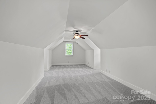bonus room featuring light colored carpet, ceiling fan, lofted ceiling, and baseboards