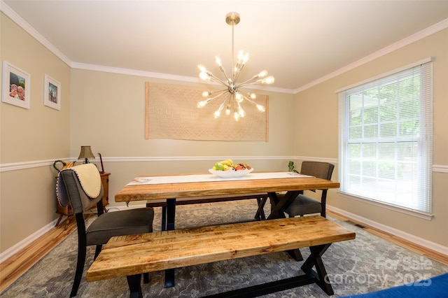 10316 Whitethorn Dr, Charlotte, NC 28277 - dining room with wood finished floors, an inviting chandelier, baseboards, ornamental molding, and visible vents